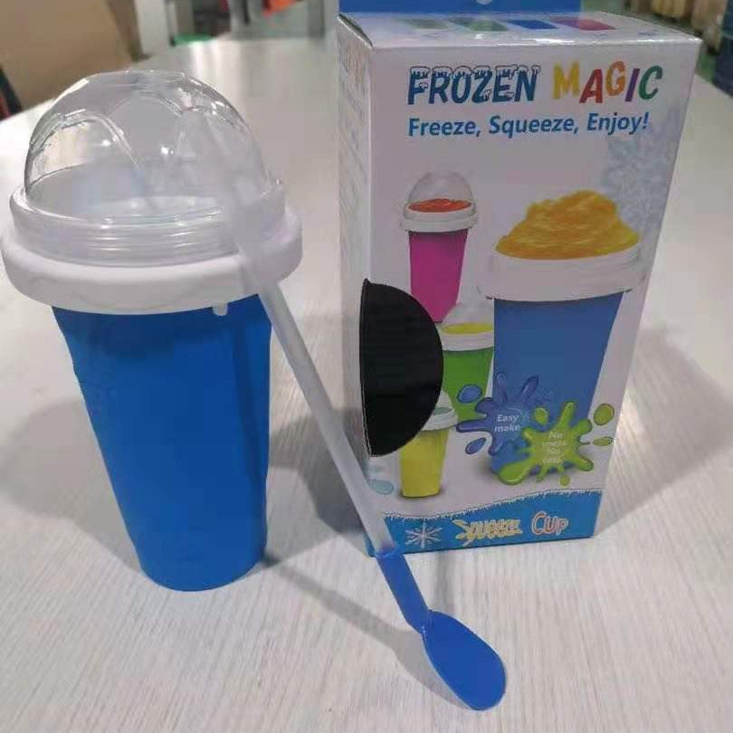 Blue ice cream maker with packaging labeled 'Frozen Magic' on a light surface.