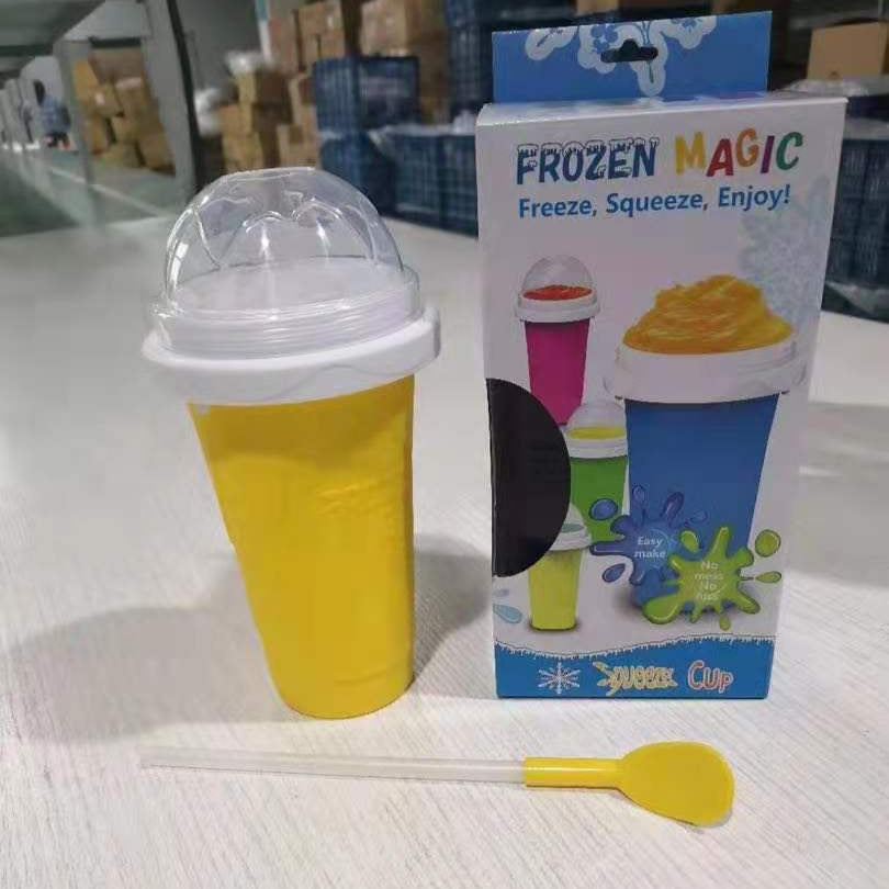 Yellow frozen magic slushy maker cup with packaging on a light surface