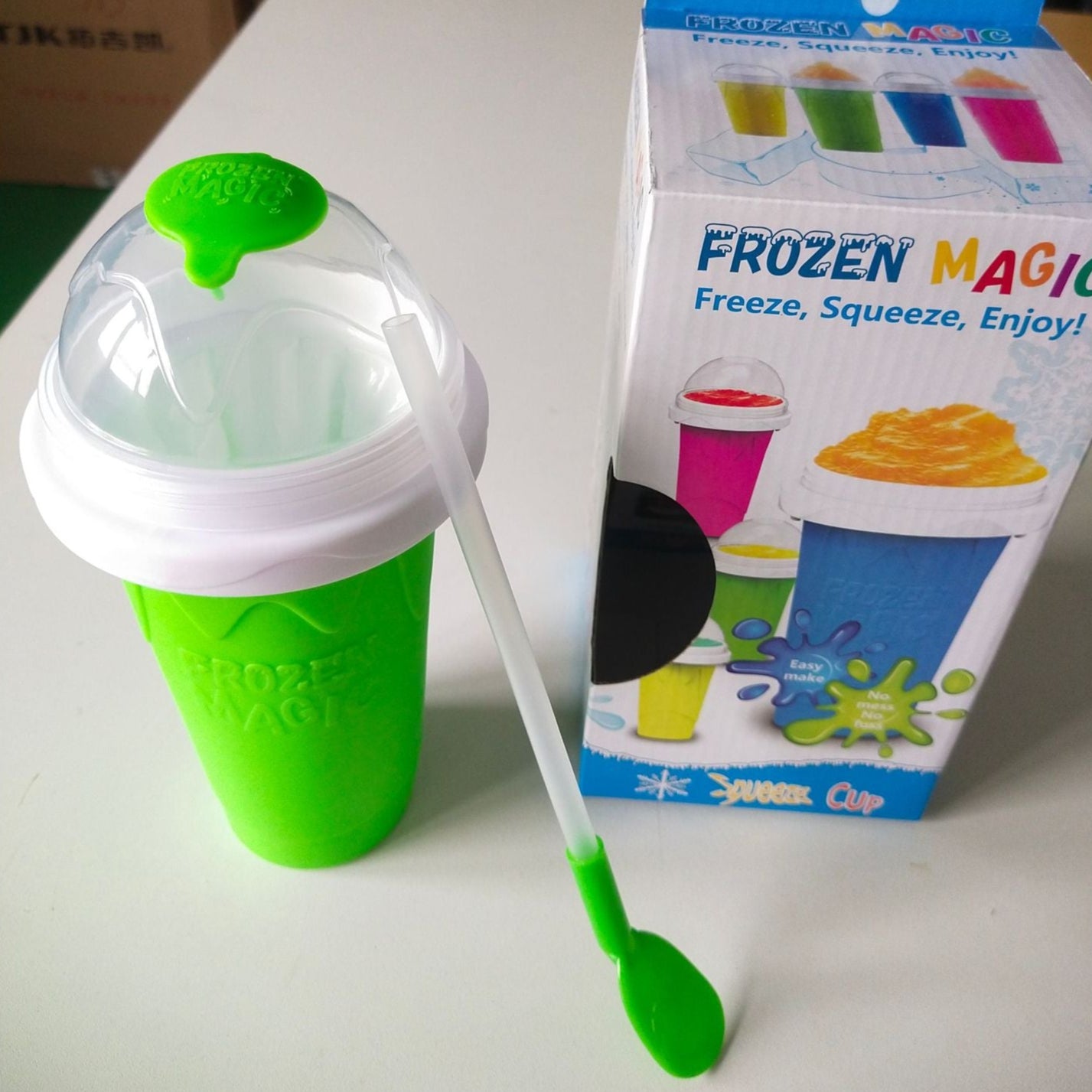 Green and white frozen magic cup with packaging in the background